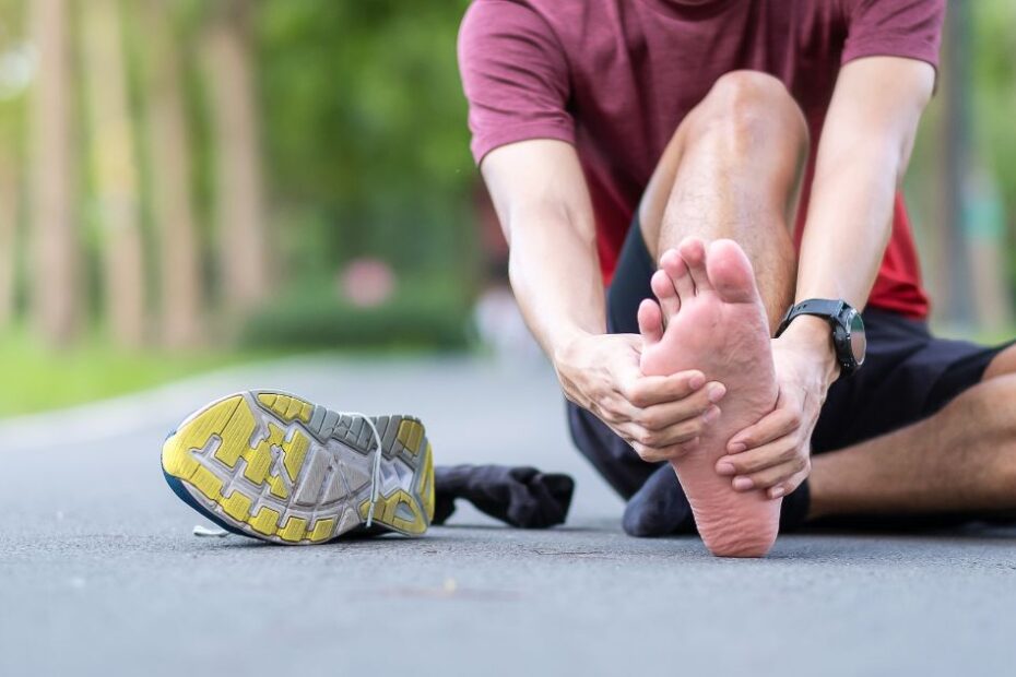 An athlete having a leg ache due to Plantar Fasciitis