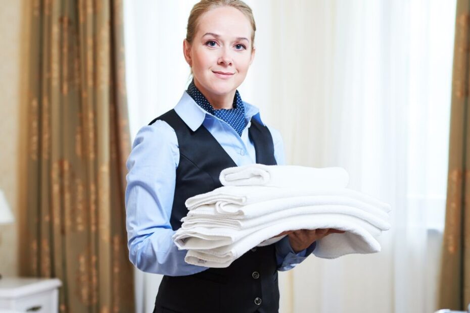 Hotel housekeeper carrying linen