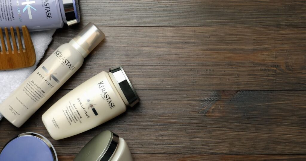 Flat Lay Composition with Kerastase Hair Care Cosmetic Products on Wooden Table