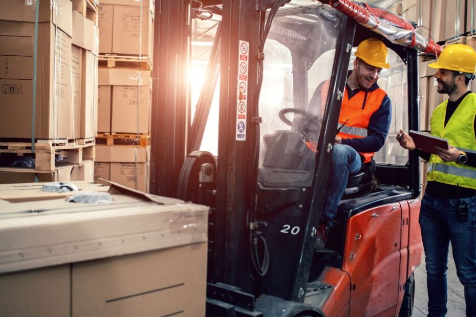 Workers in warehouse with forklift