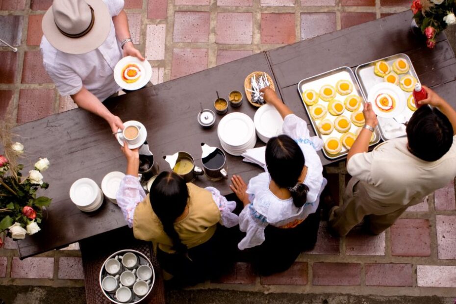 People getting served food at a hotel table outside