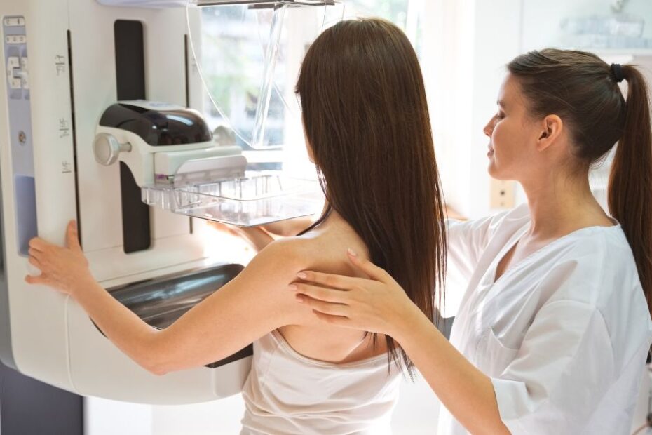 Nurse and patient during Mammography test in examination room