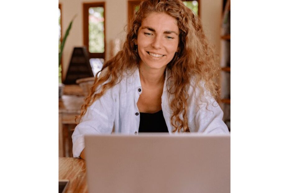 Woman smiling looking at a laptop