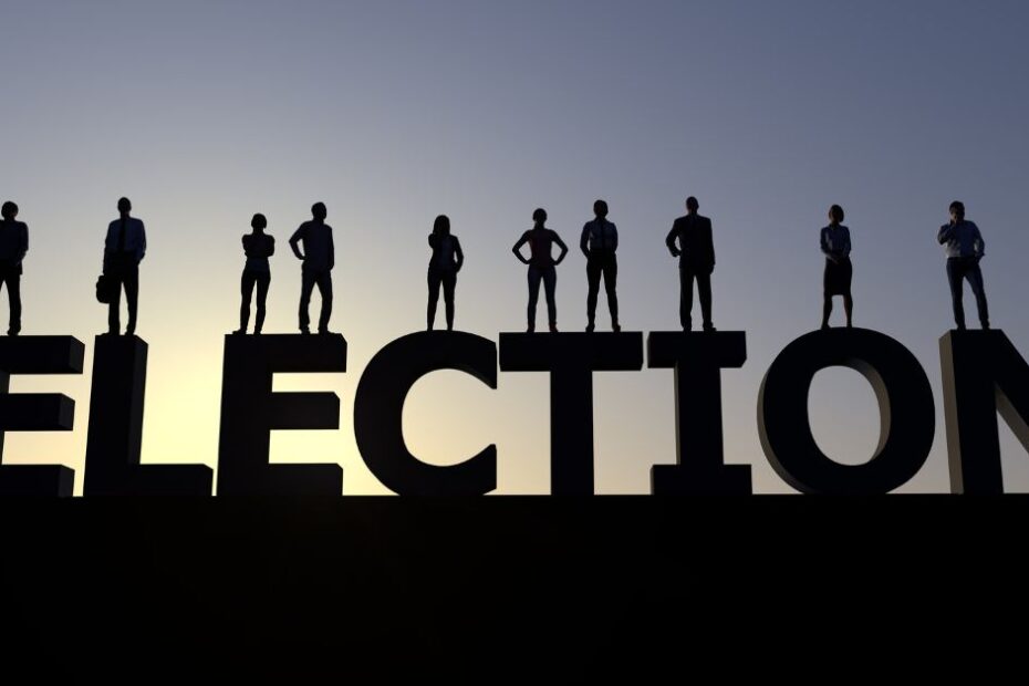 A group of people standing on the word election