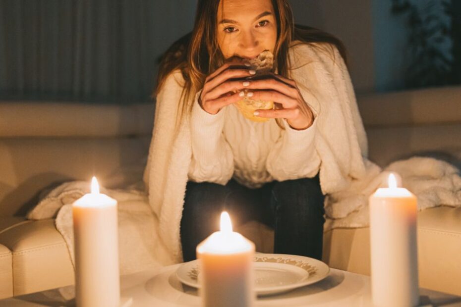 A woman during a power outage with candles on