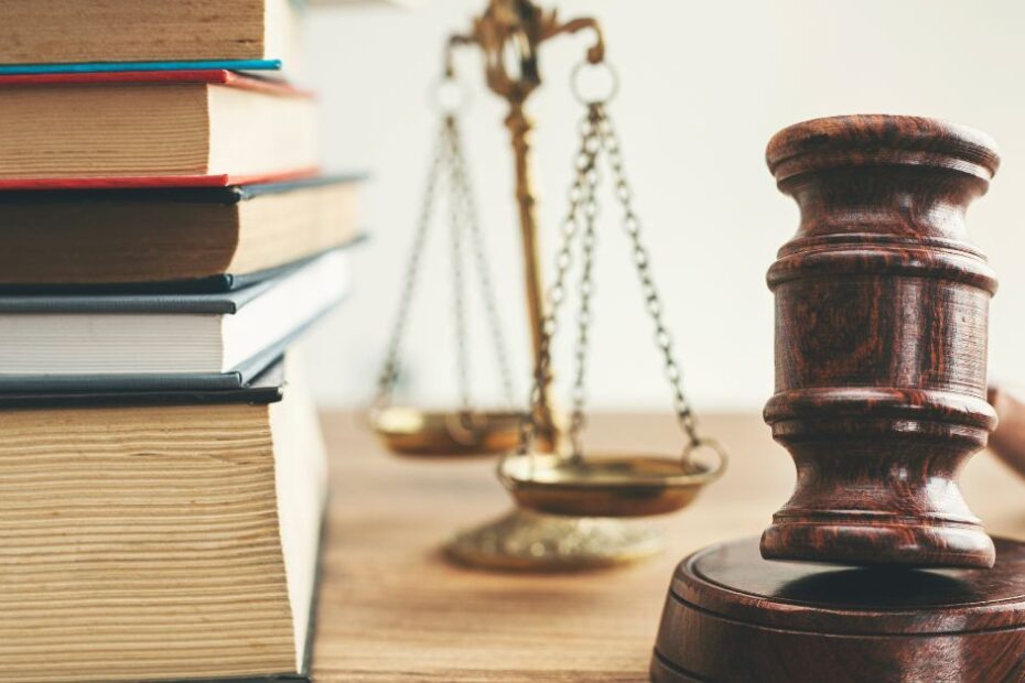 Law books and scales of justice on a desk