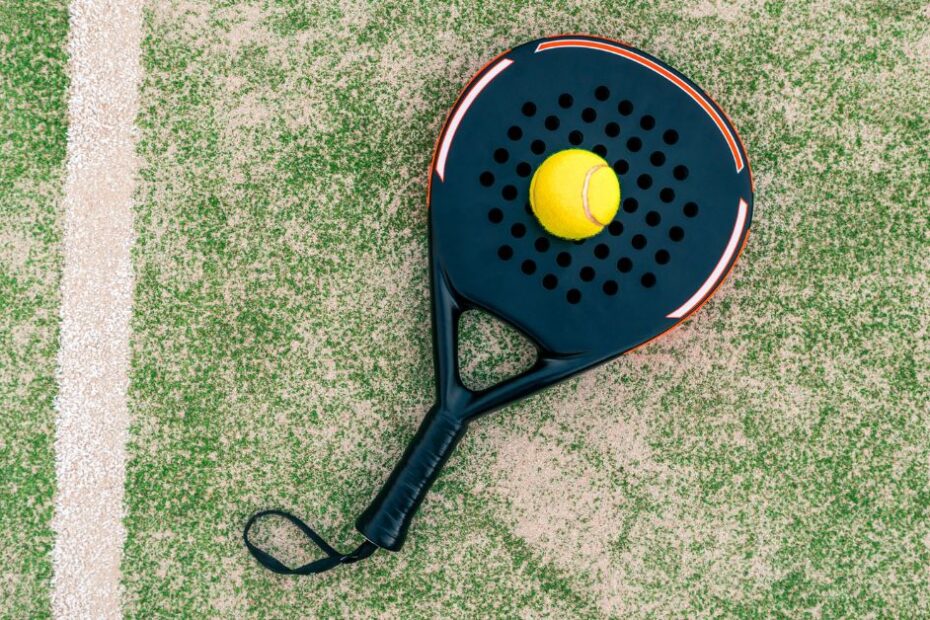 Yellow ball on top of a padel racket