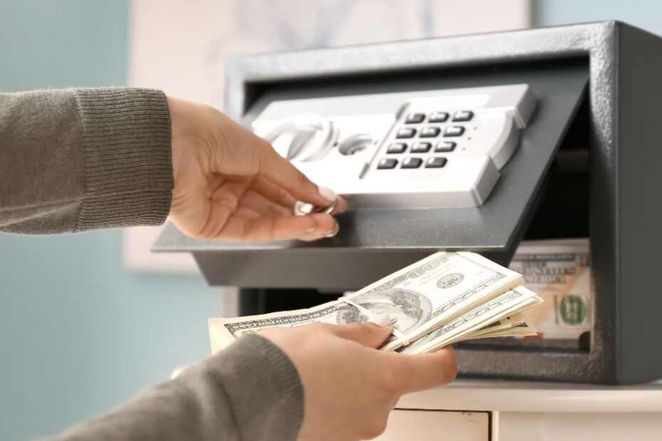 Woman Putting Money in a Safe