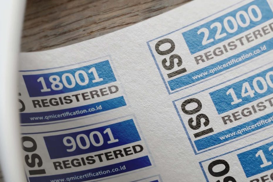 ISO certification stickers with registration numbers on paper.