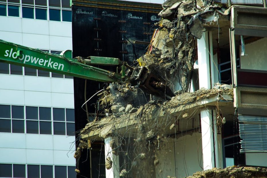 A detailed view of urban building demolition using heavy machinery, showcasing industrial decay.