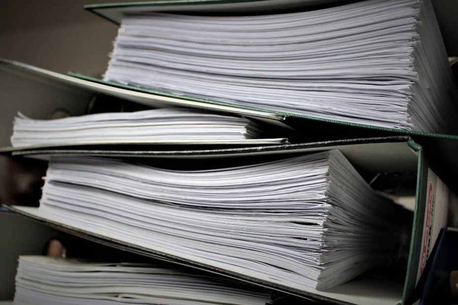 Close-up of stacked binders filled with documents for office or educational use.