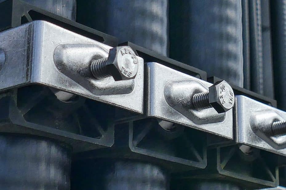 Detailed macro shot of metal bolts securing industrial machinery parts.