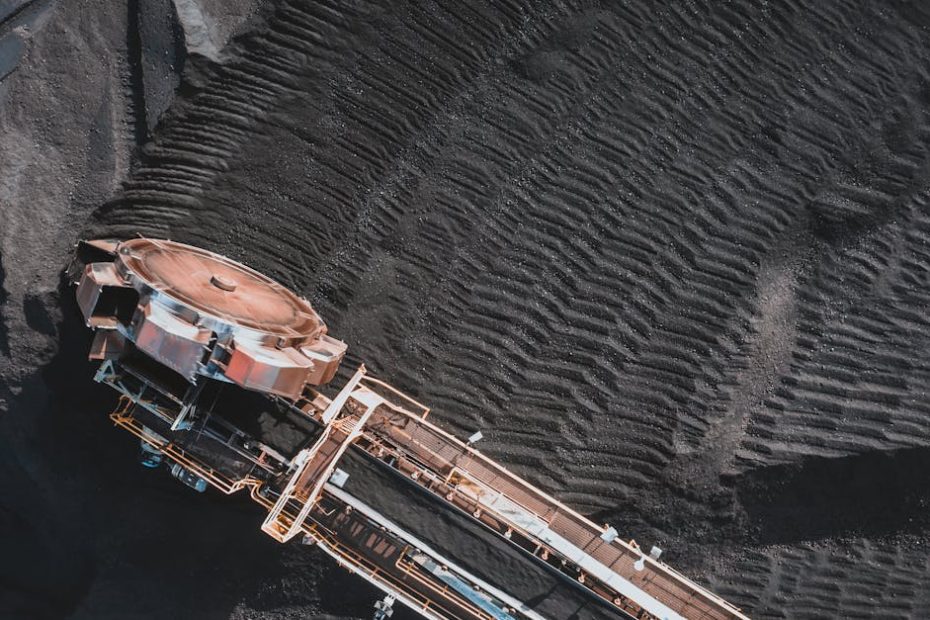 Aerial view of an industrial conveyor system at a coal mining site, showcasing engineering and machinery.