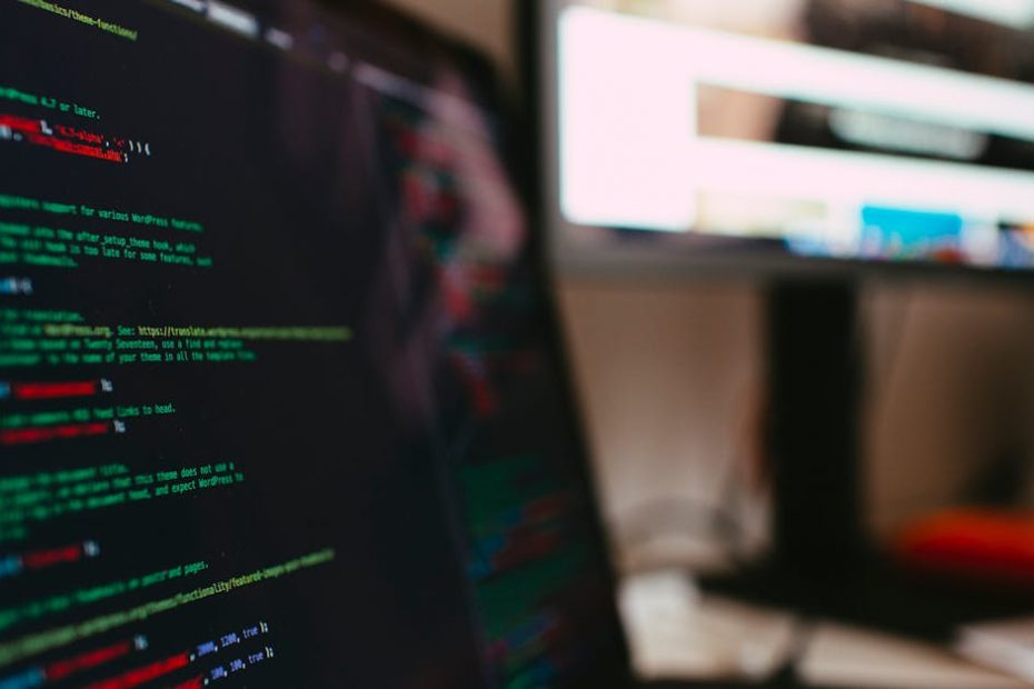 A detailed view of programming code displayed on a laptop screen, depicting a tech workspace.