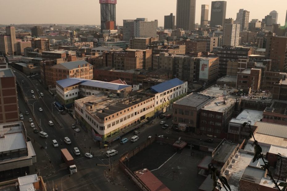 Scenic aerial view of Johannesburg cityscape showcasing urban architecture in warm evening light.