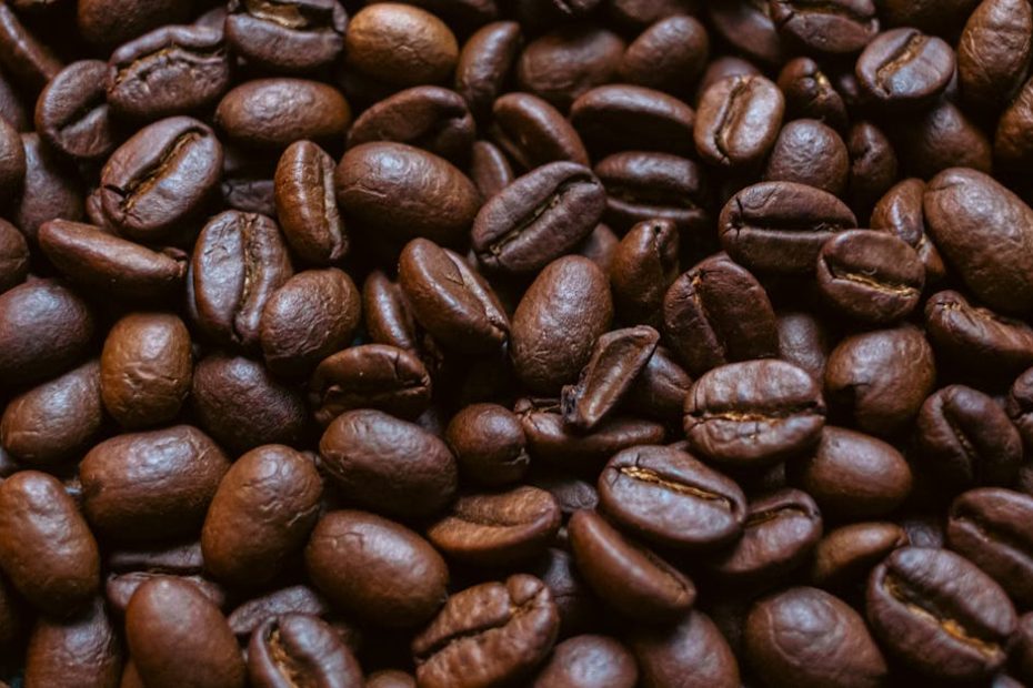 Rich brown roasted coffee beans filling the frame, perfect for coffee enthusiasts.