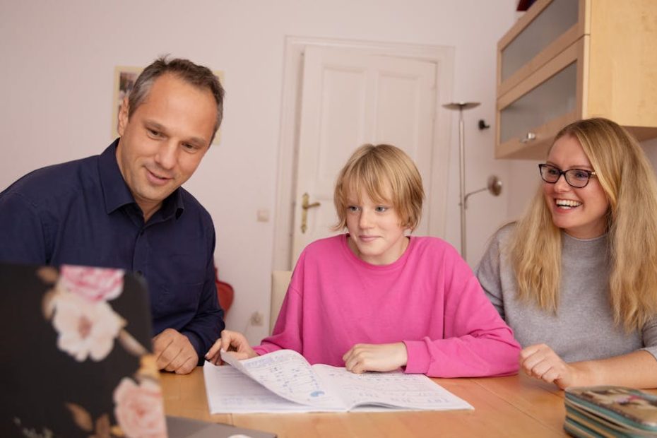 Family engaged in online learning together at home using laptop, focusing on education and connection.