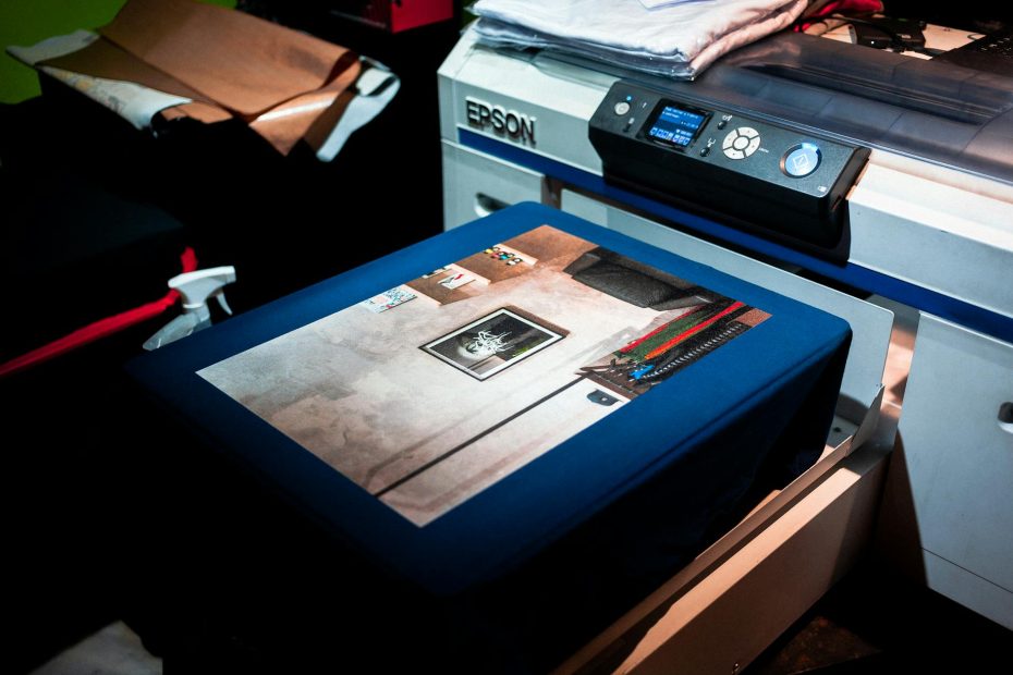 Close-up of a professional printer printing custom artwork on fabric