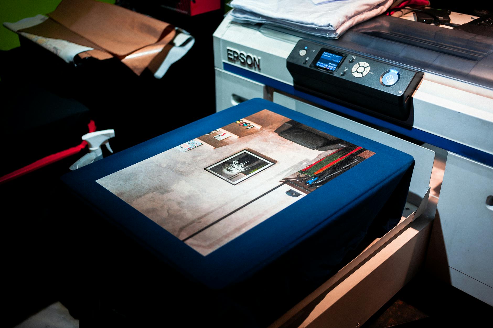 Close-up of a professional printer printing custom artwork on fabric