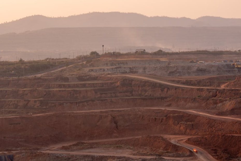 Aerial view of an expansive quarry landscape under a warm sunset glow.