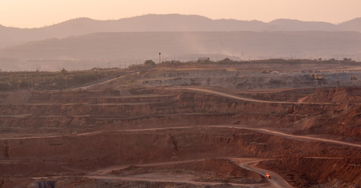 Aerial view of an expansive quarry landscape under a warm sunset glow.