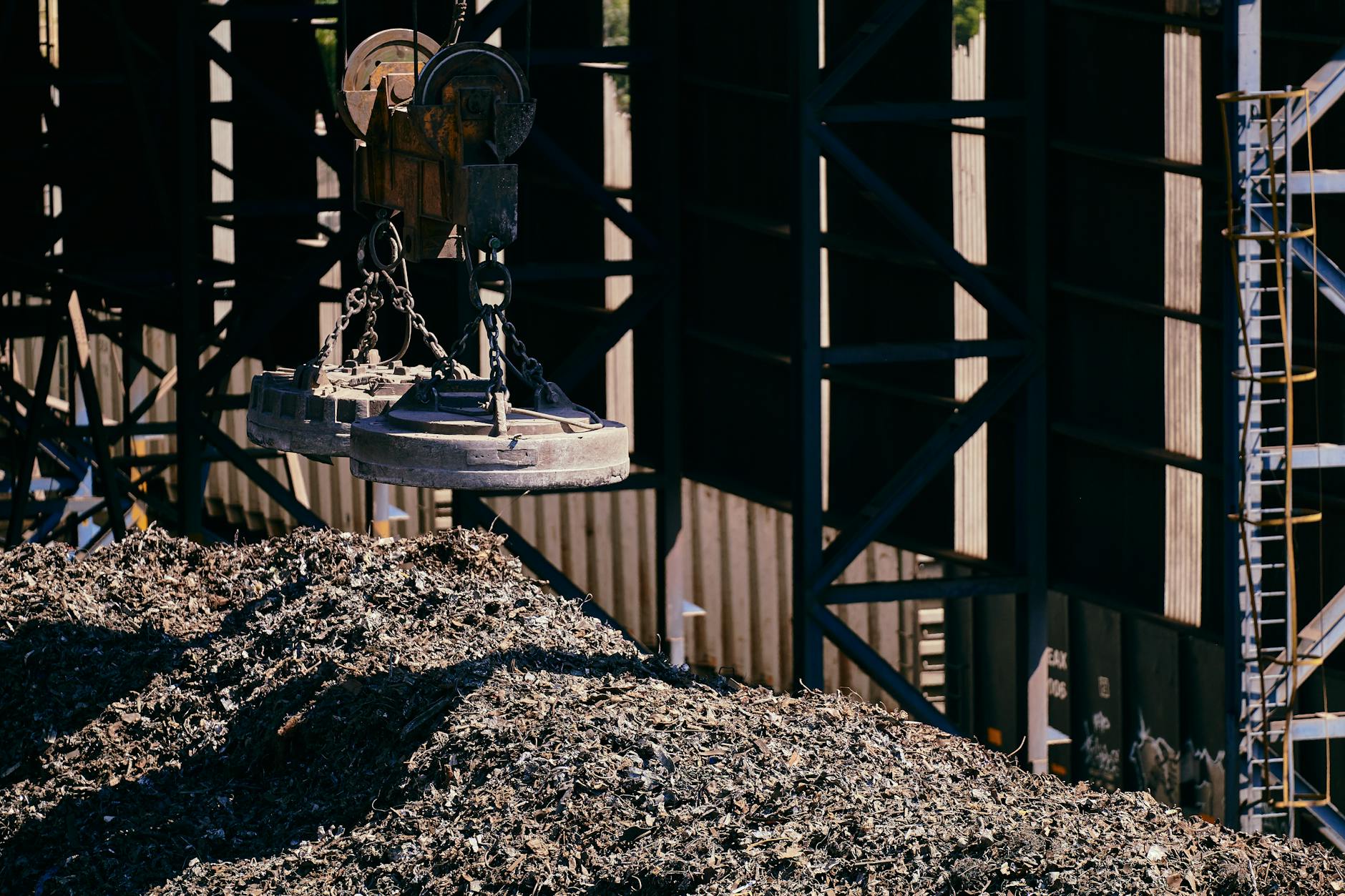 Heavy-duty magnet crane operating in an industrial scrap metal yard