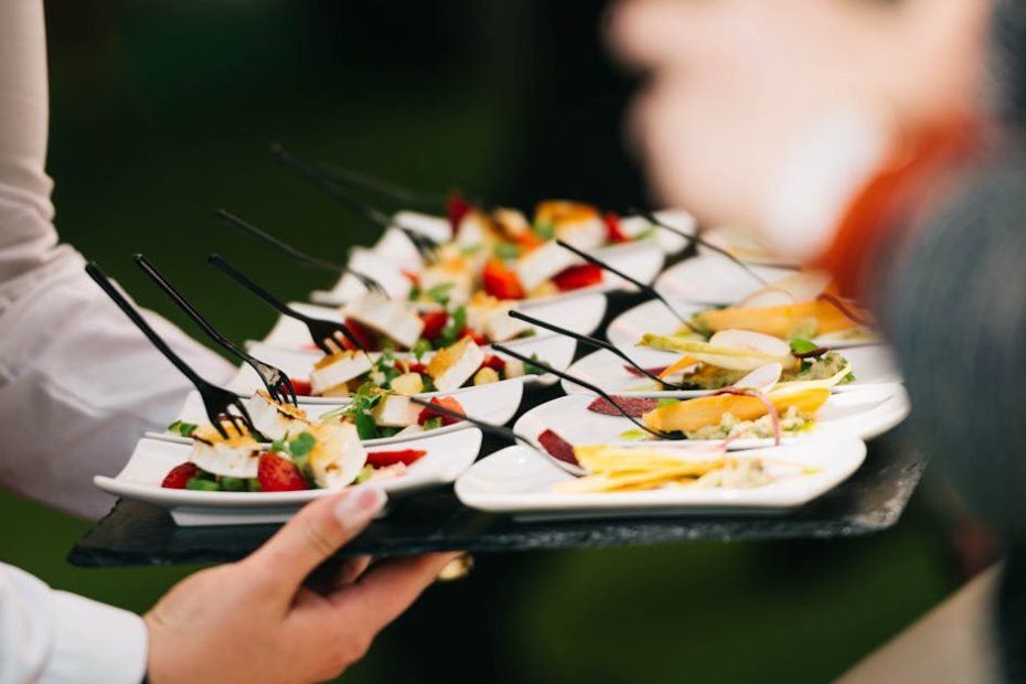 Elegant catering presentation with gourmet appetizers on a tray at a social event.