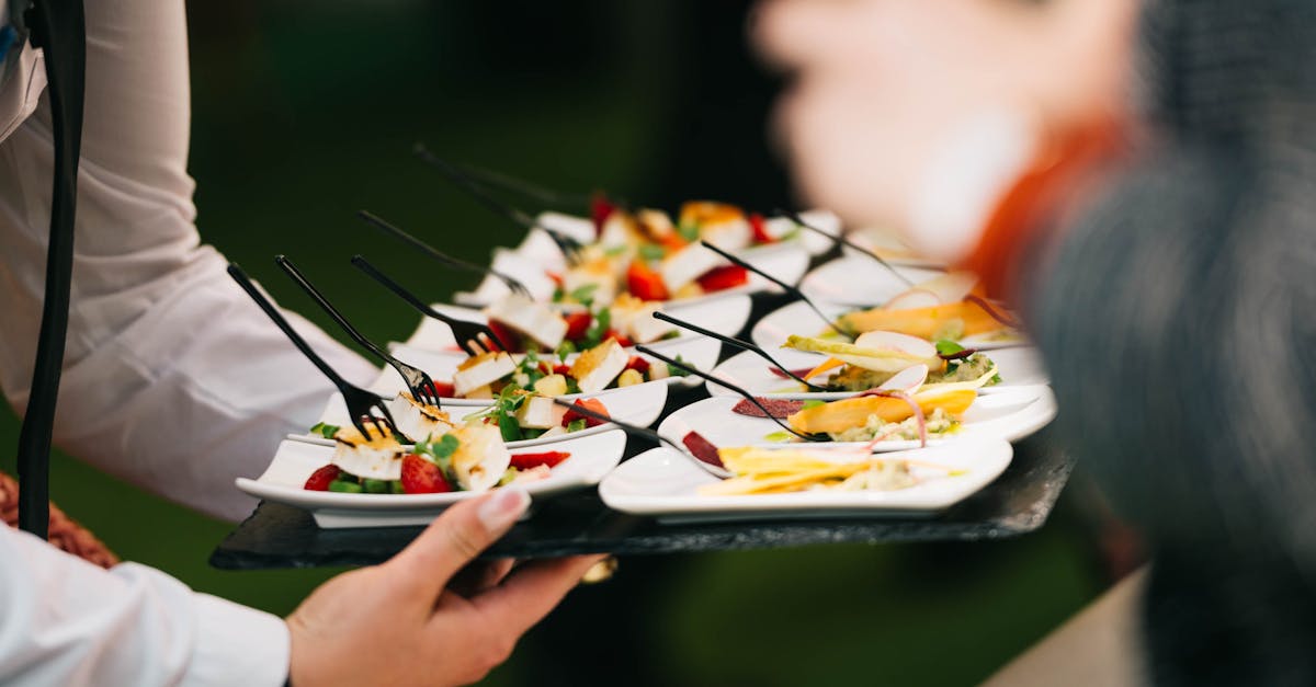 Elegant catering presentation with gourmet appetizers on a tray at a social event.