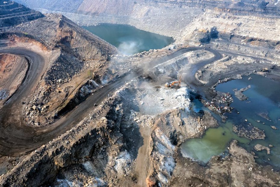 Expansive aerial shot of an active coal mine in Dhanbad, Jharkhand, India.